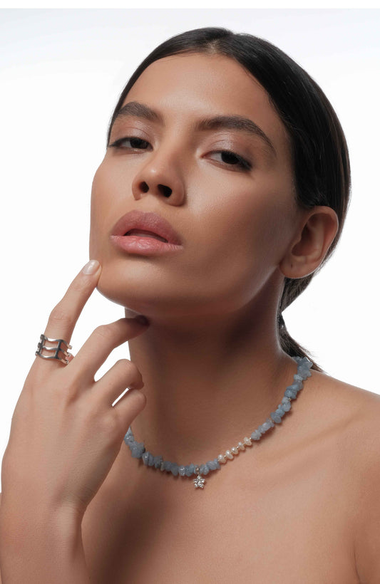 Necklace with blue gemstone and silver ring